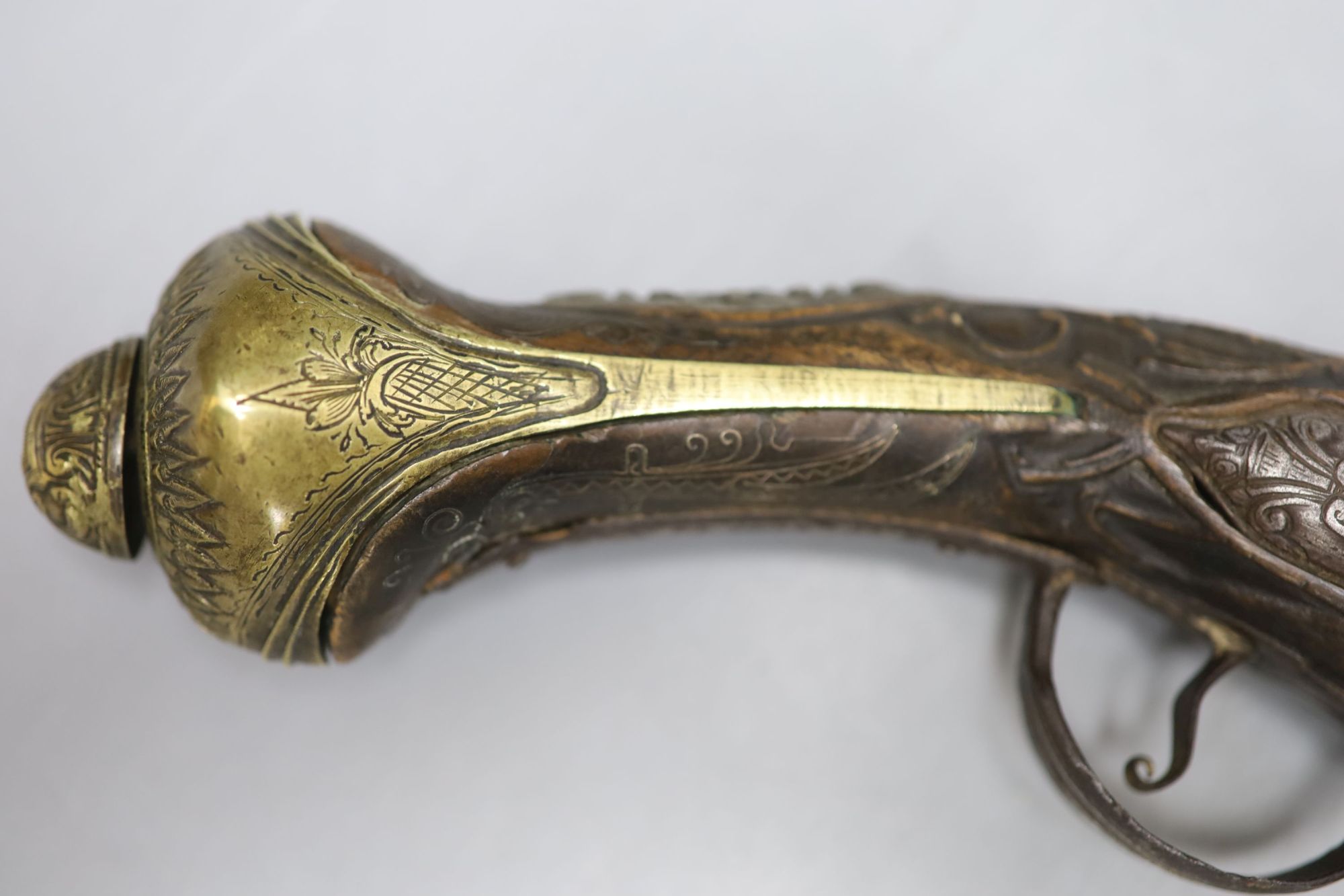 A 19th century Ottoman carved wood and brass mounted flintlock pistol, length 45cm